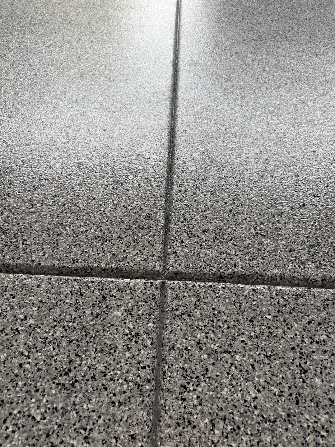 Close-up of black and white epoxy flake floor texture